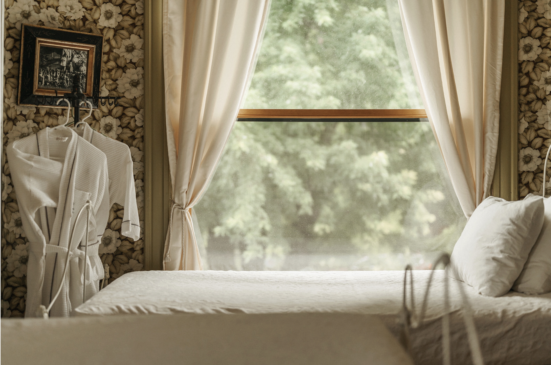 photo of hotel room with bed and robes